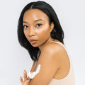 Model is using Scrub & Butter Body Butter on her arms.