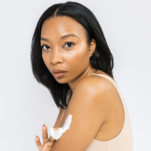 Model is using Scrub & Butter Body Butter on her arms.