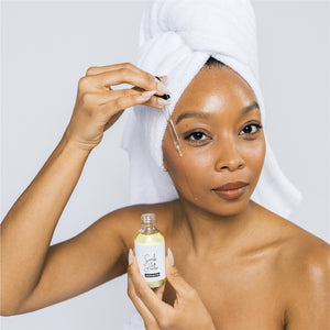 Model using Scrub & Butter Liquid Butter on her face.