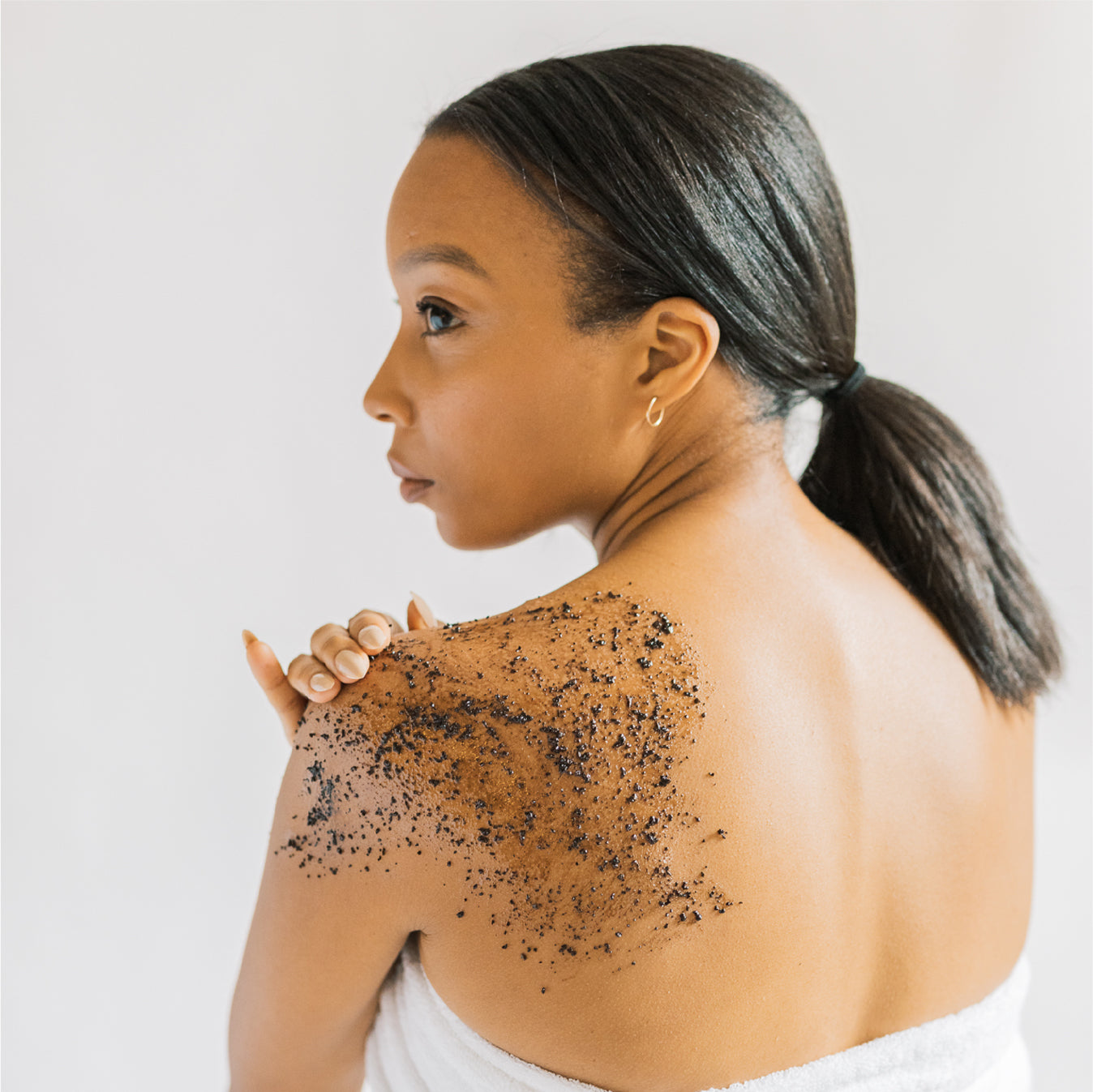 Model using Scrub & Butter Coffee Scrub on her back.
